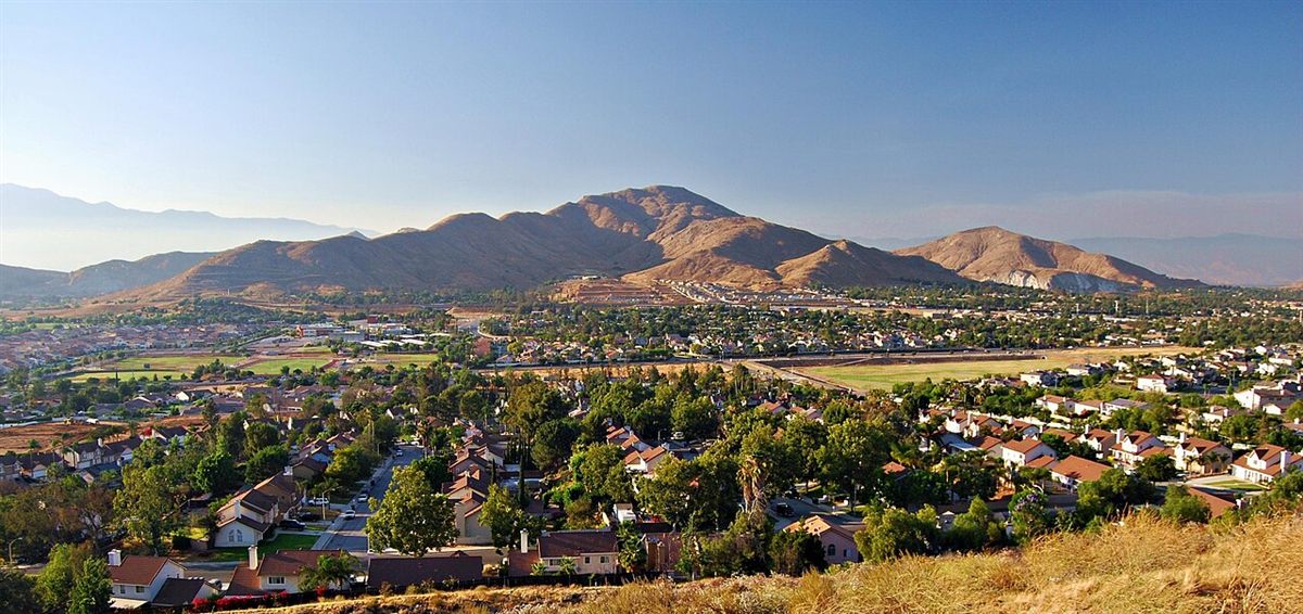 Aerial view of Jurupa Valley neighborhoods with Mount Jurupa and the Santa Ana Mountains behind